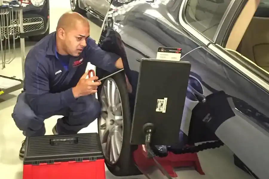 Technician working on a car providing Paintless dent removal Westchester NY